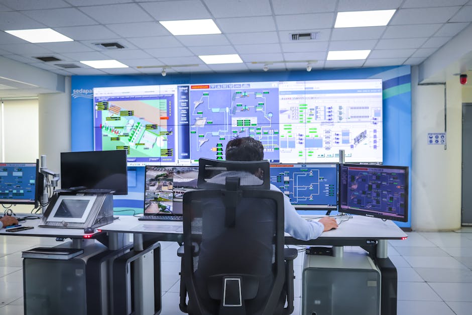 Operator in a modern control room managing technological systems.